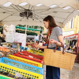a woman shopping at a farmers market